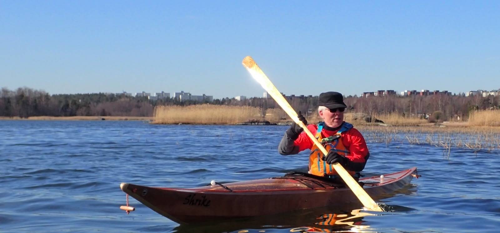 People kayaking on a calm lake at sunset